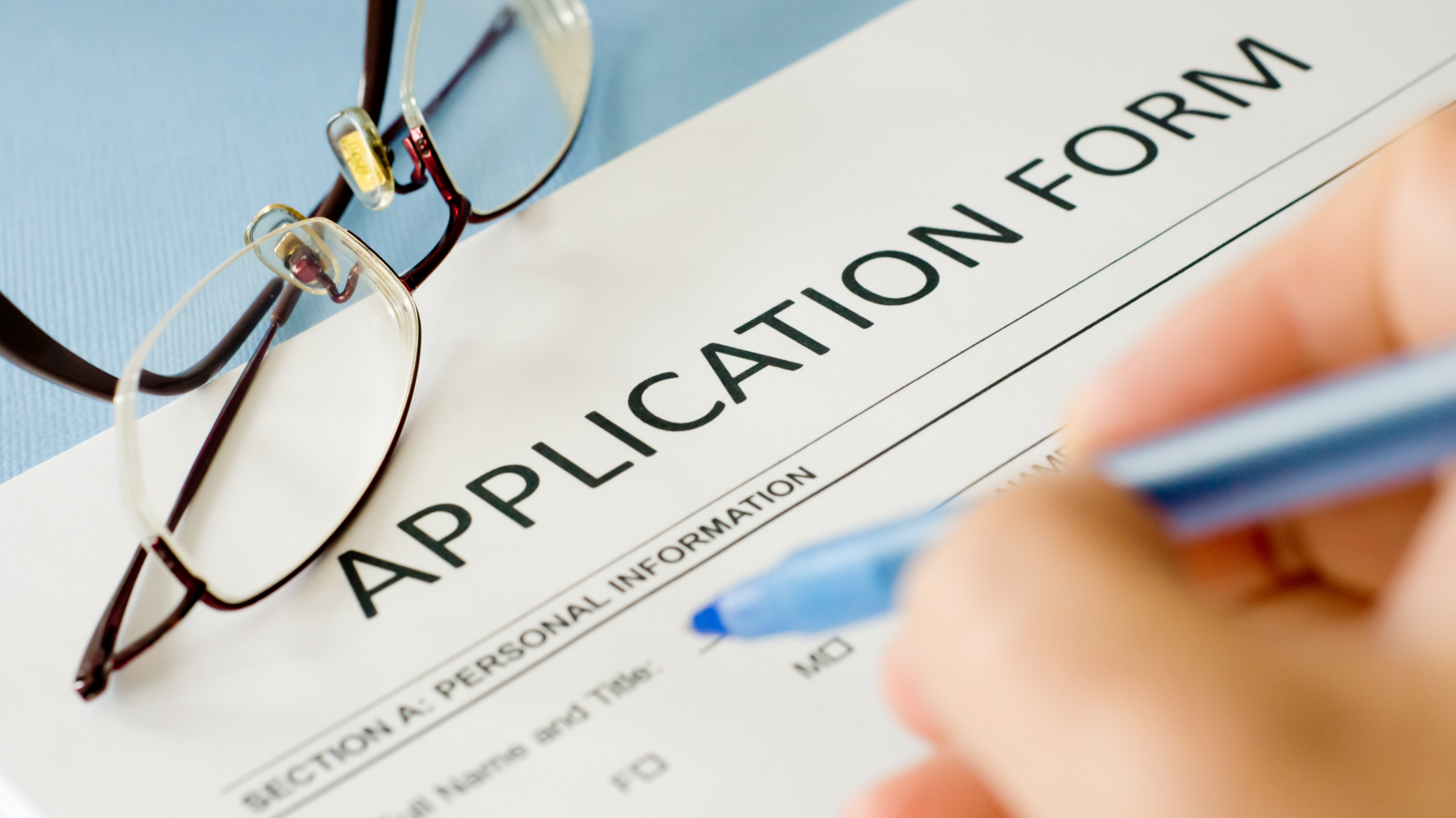 applicant filling out paper application form